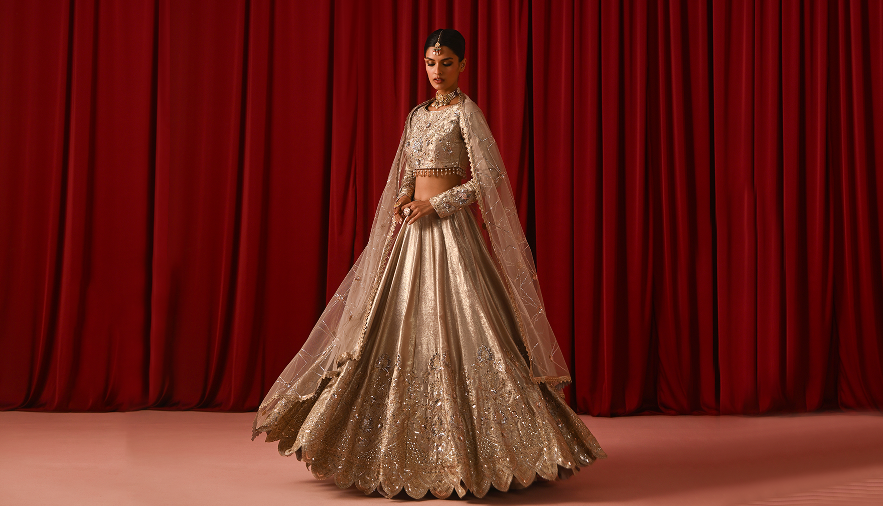 Woman twirling in elegant metallic lehenga style