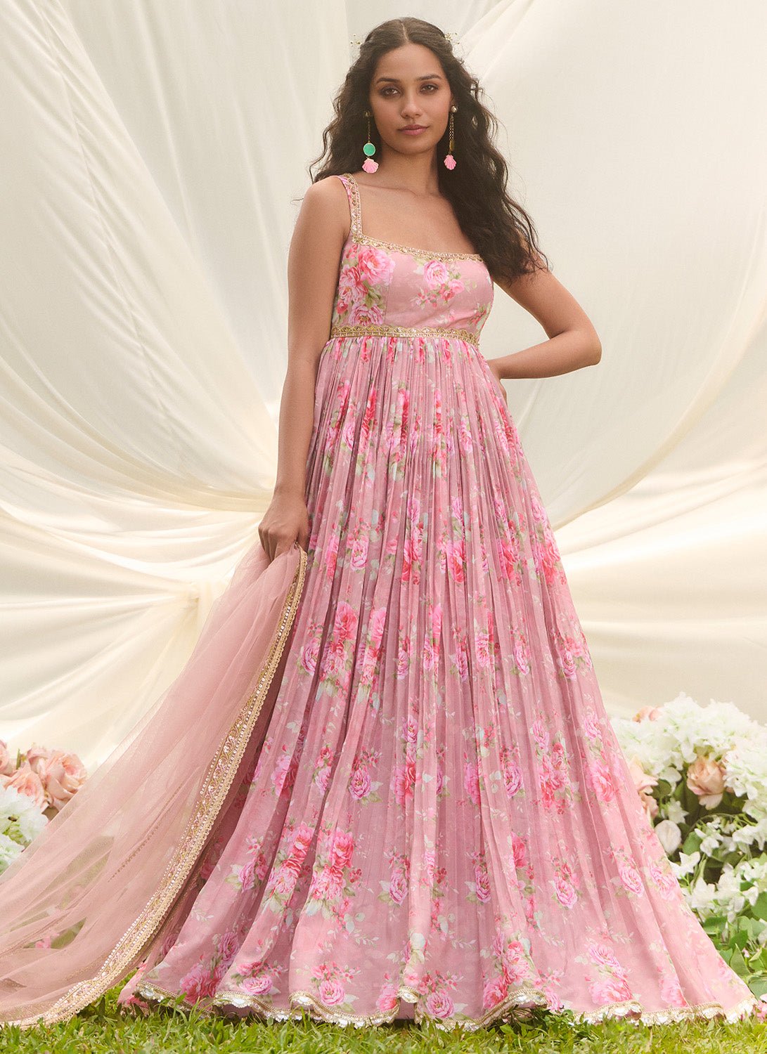 dusty pink anarkali dress A timeless dusty-rose pink Anarkali gown crafted in flowing, lightweight fabric that drapes gracefully with every movement. The outfit features delicate handcrafted embroidery along the neckline, adding a soft regal charm without