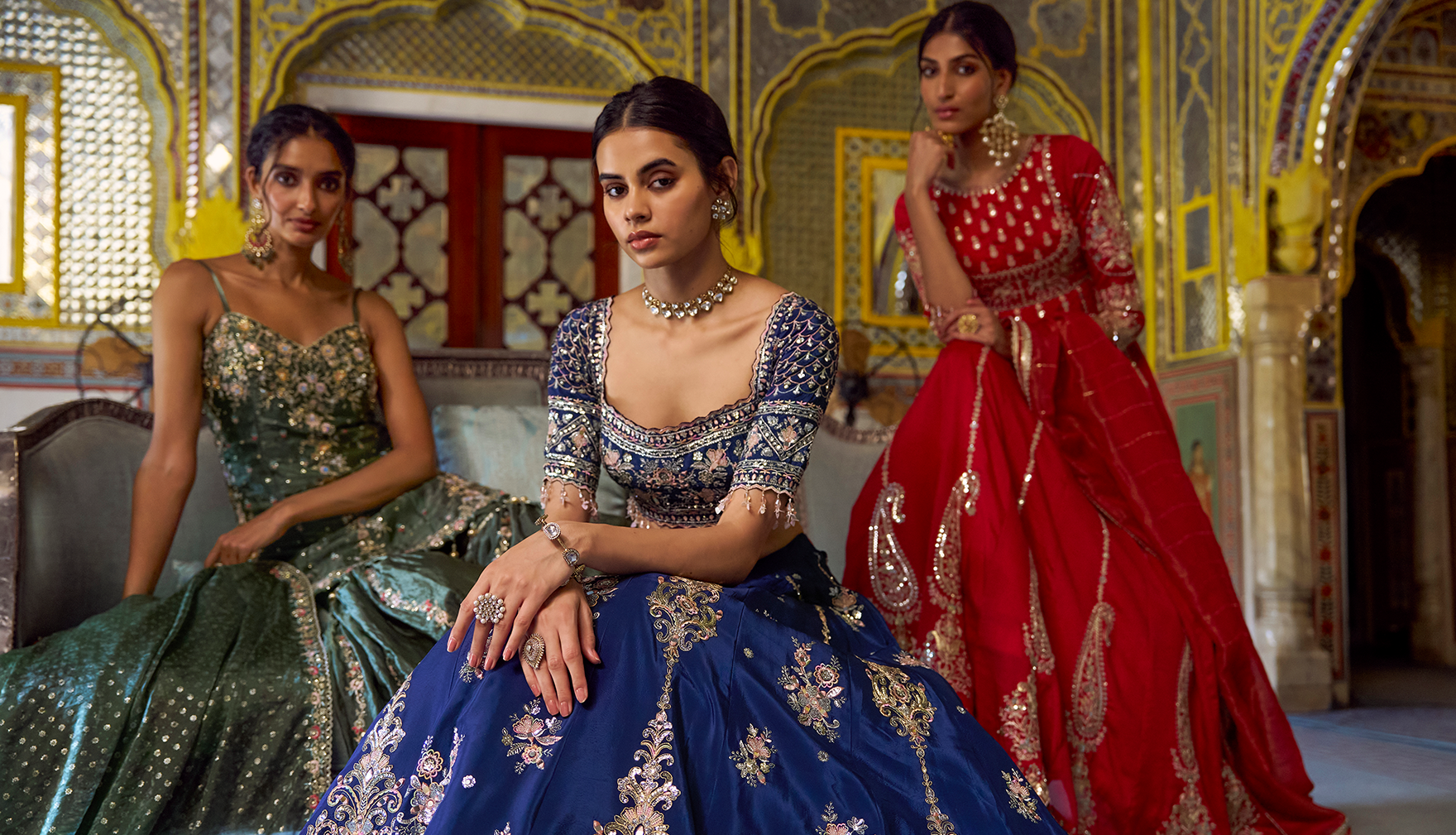 Three women in vibrant Indian attire