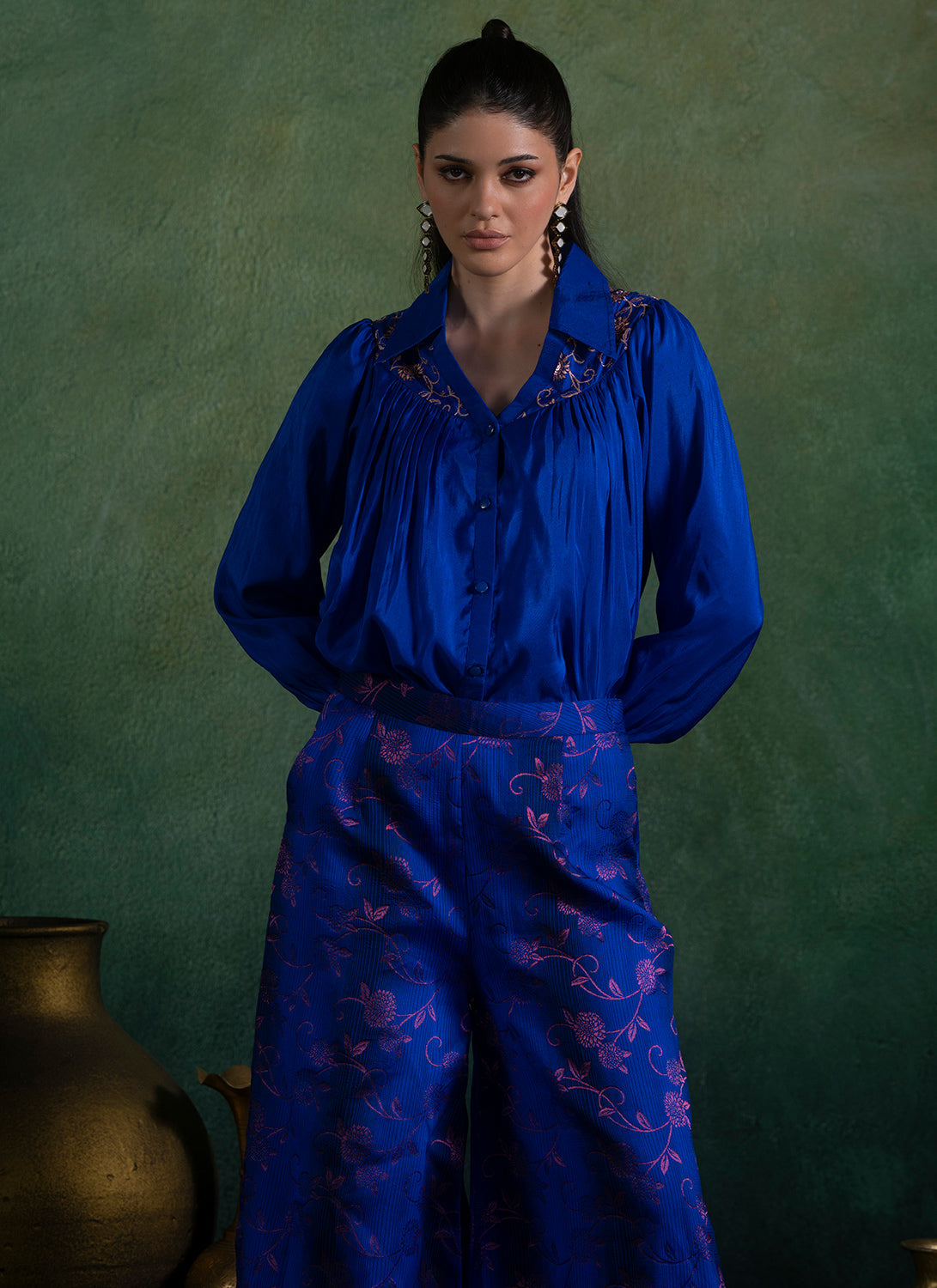Woman wearing royal blue brocade fabric blouse and pant set